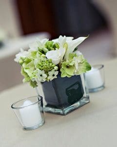 Classical white cocktail decoration in glass vase, with tealights