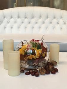 Fall table decoration with chestnuts and candles
