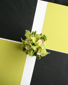 Green cymbidium orchids in glass cube