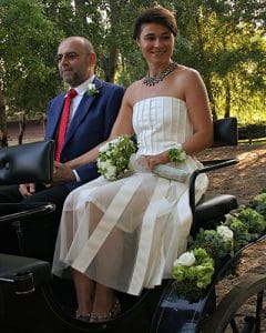 Wedding corsage on the arm of the bride sitting in the carriage
